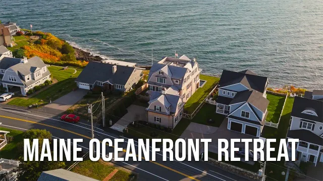 Aerial view of houses along the shoreline with the ocean in the background at Maine Oceanfront Retreat.