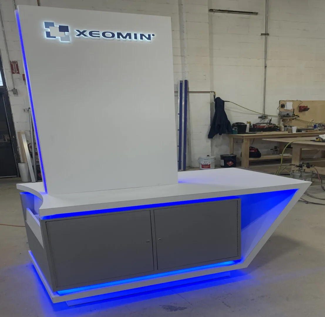 White illuminated reception desk with Xeomin logo