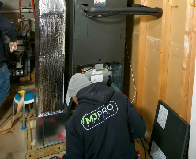 Technician inspecting a home heating system