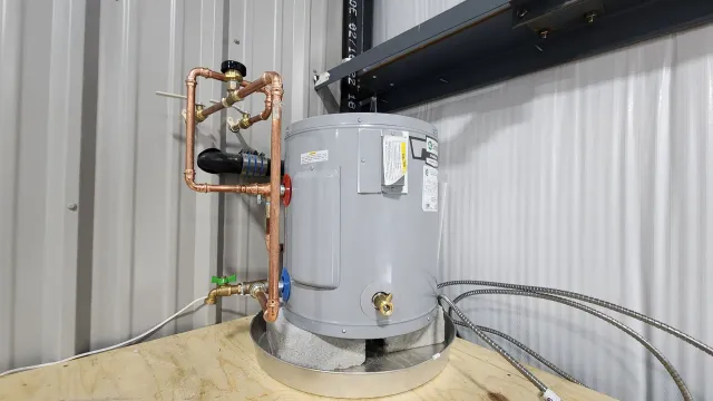 A water heater is sitting on top of a wooden floor in a building.