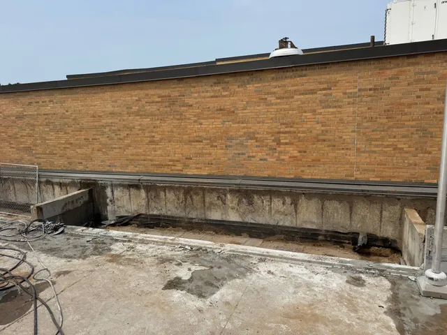 Commercial building wall saw cutting along brick facade for renovation