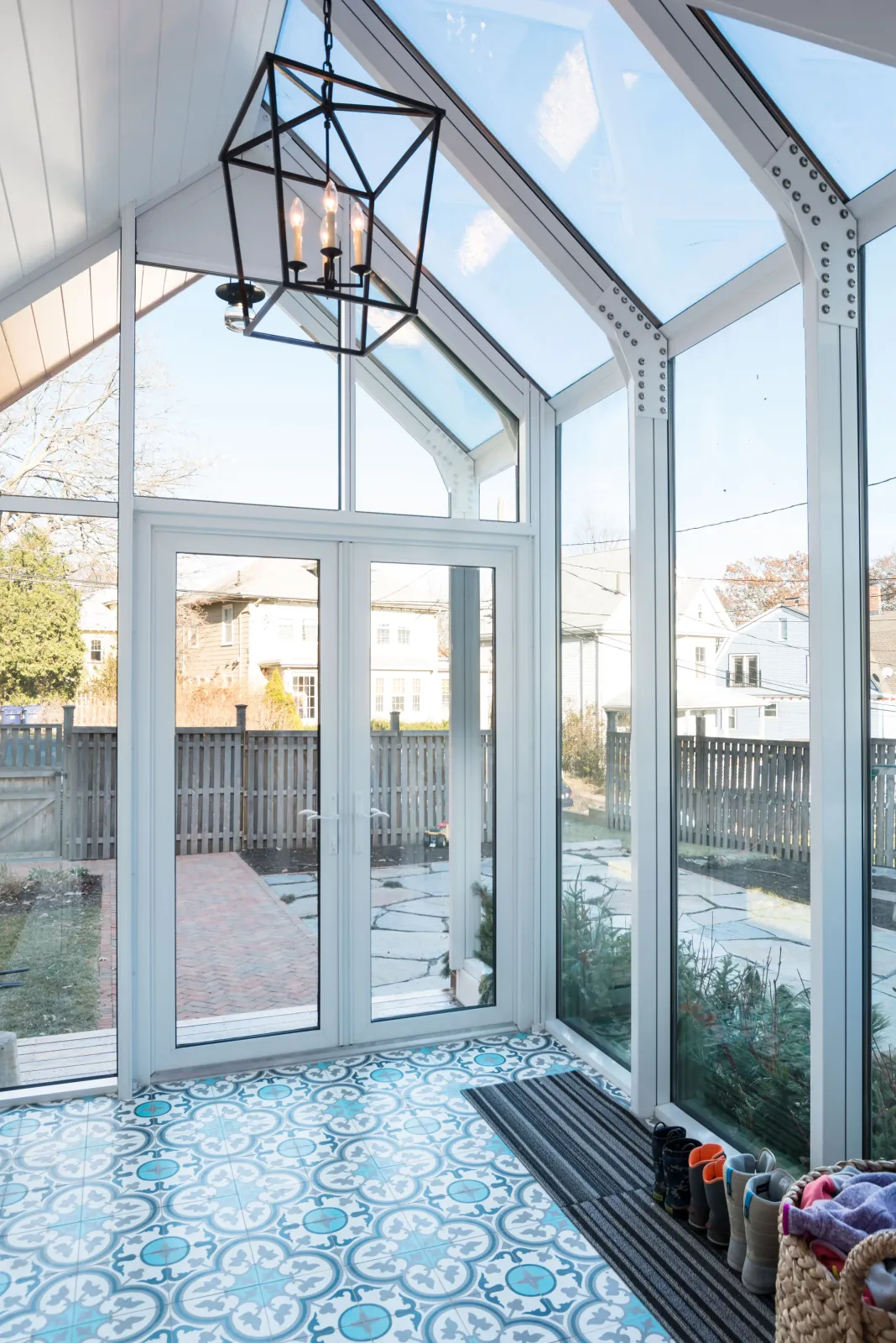 Jamaica Plain, MA -- "Sunroom mudroom." This back entry expansion project transformed a cramped doorway into a welcoming and functional vestibule for this bustling family home.