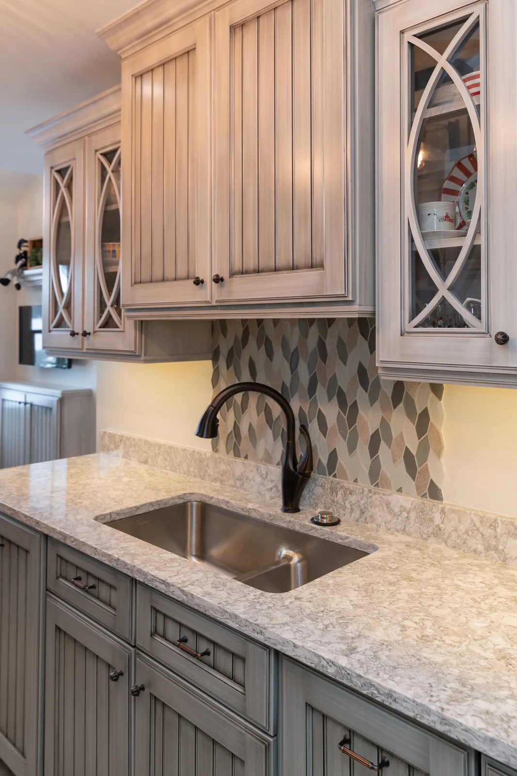 Custom cabinetry, quartz counter and tile backsplash detail