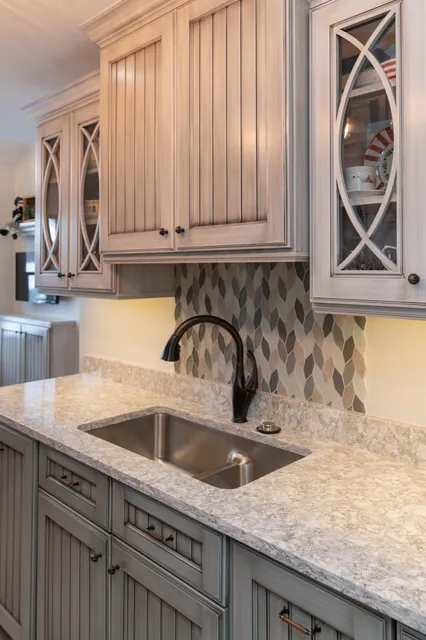Custom cabinetry, quartz counter and tile backsplash detail