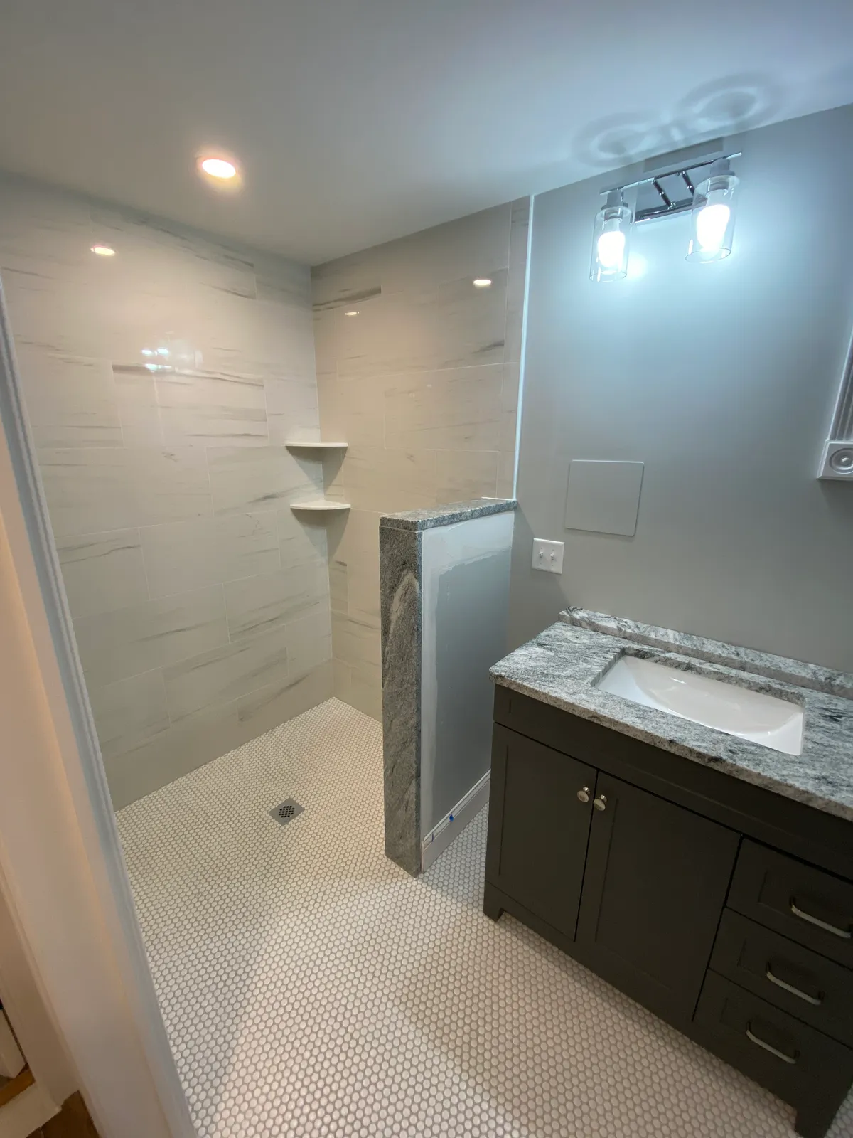 Bathroom remodel with granite vanity and penny tile