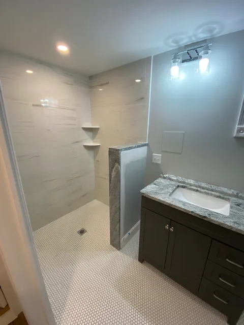 Bathroom remodel with granite vanity and penny tile