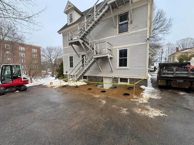 Compact excavator performing site preparation in Hampton, NH