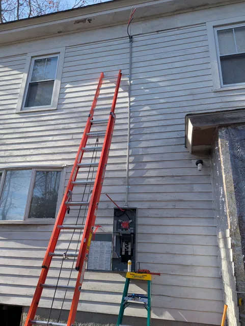 Service mast installation on a home exterior