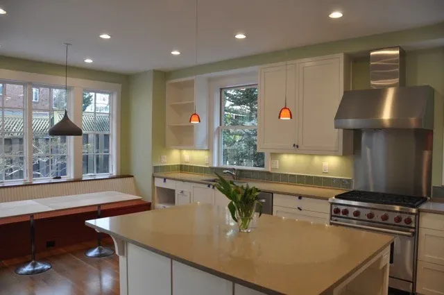 Kitchen with window seat, pendant lighting and pro range