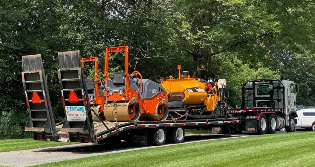 A truck is carrying a bunch of machinery on a trailer.