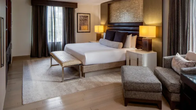 Hotel guest room with framed headboard wall, bedside cabinetry and wood trim in Orange, Connecticut.