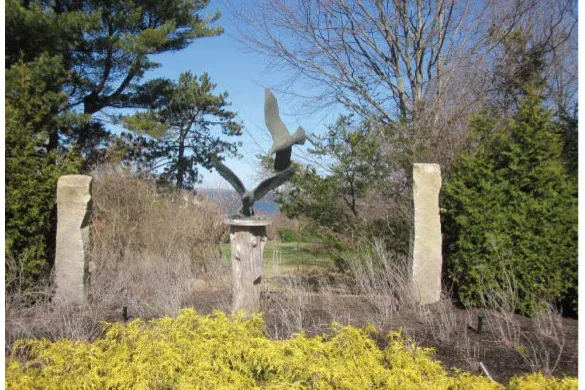 Bird sculpture installation framed by granite posts