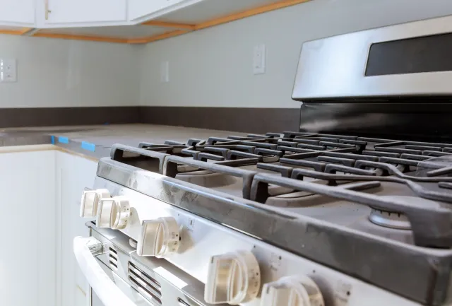A stove top oven is sitting on top of a counter in a kitchen.