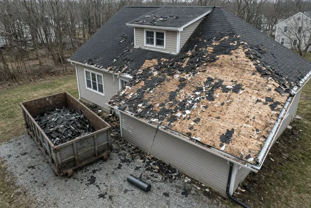 Overhead drone still of a Helio GC roof tear-off with dumpster in the drive