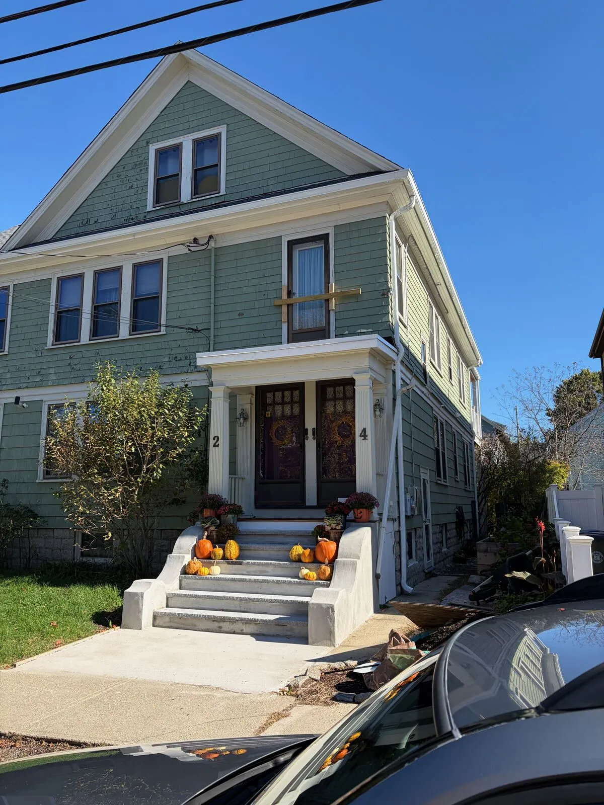 Complete shingle replacement on a green Victorian. Color-matched flashings and copper drip edge details.