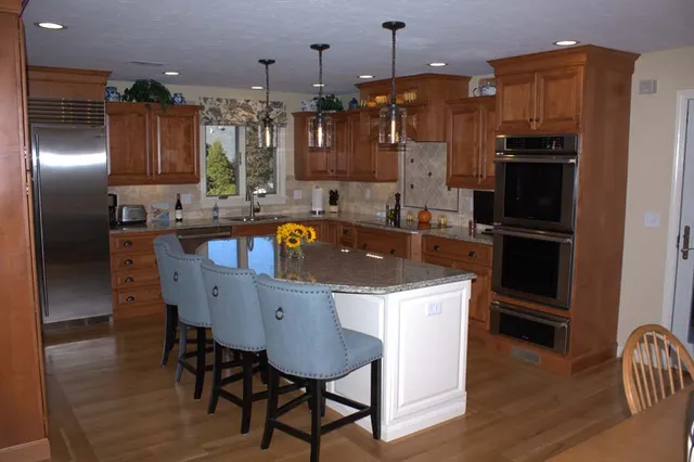 Cherry kitchen with granite island and double wall ovens