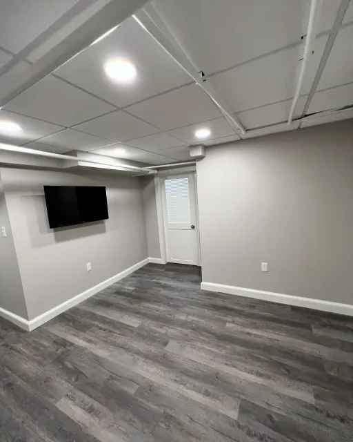 Transformed a previously underused basement into a functional and inviting space. We installed soffits for easier maintenance and to maximize ceiling height, giving the room a more open feel. 

The laundry area was reorganized with hidden machinery f