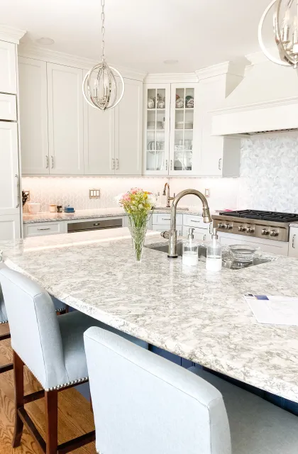 A transitional kitchen remodel in Worcester, MA with custom mosaic backsplash and elegant fixtures.