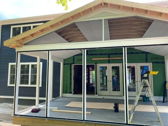 During: screen frames going in under a half-finished gable ceiling on the same porch