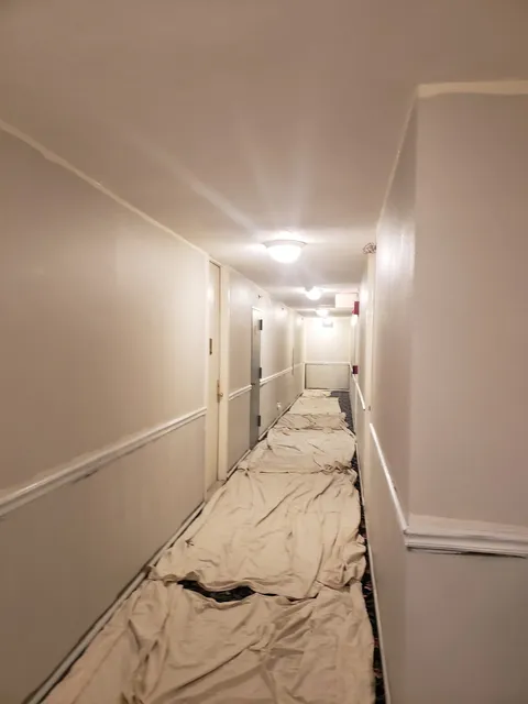 Corridor masked with drop cloths during interior painting