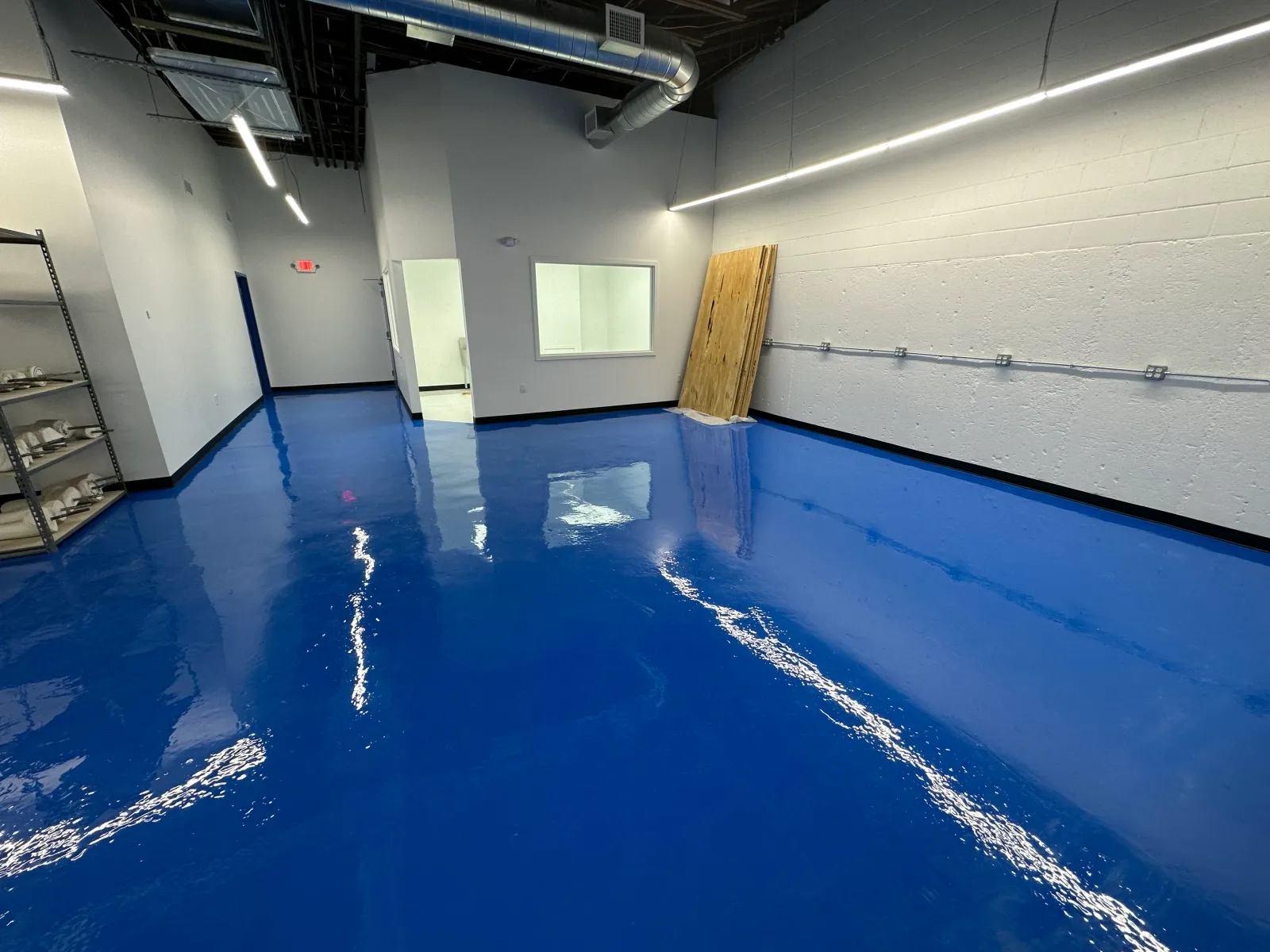 Finished blue epoxy floor coating in a commercial space