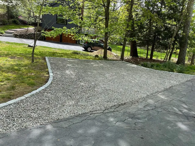 Just wrapped up this stone parking pad with cobblestone edging, great work team! #hardscape #caterpillar #cobblestone