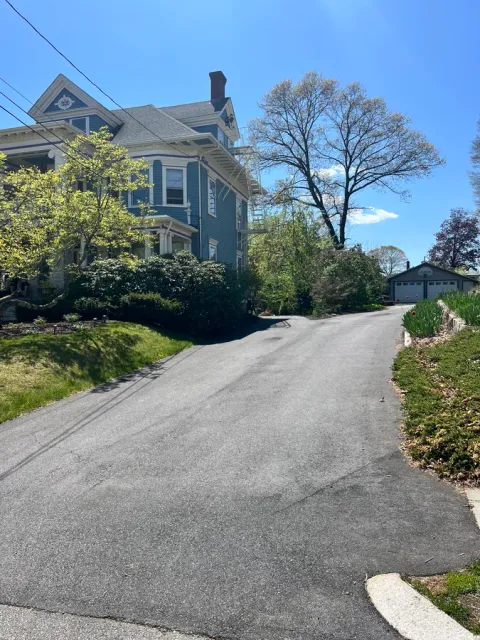 Cracked driveway showing UV fade and wear