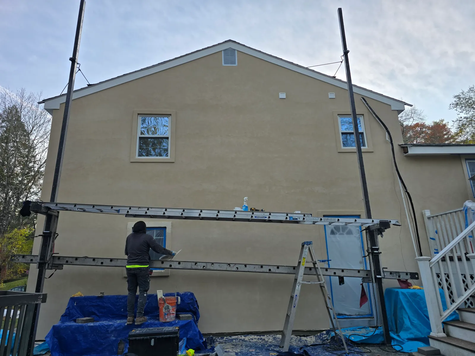 Stucco work in progress on a house exterior