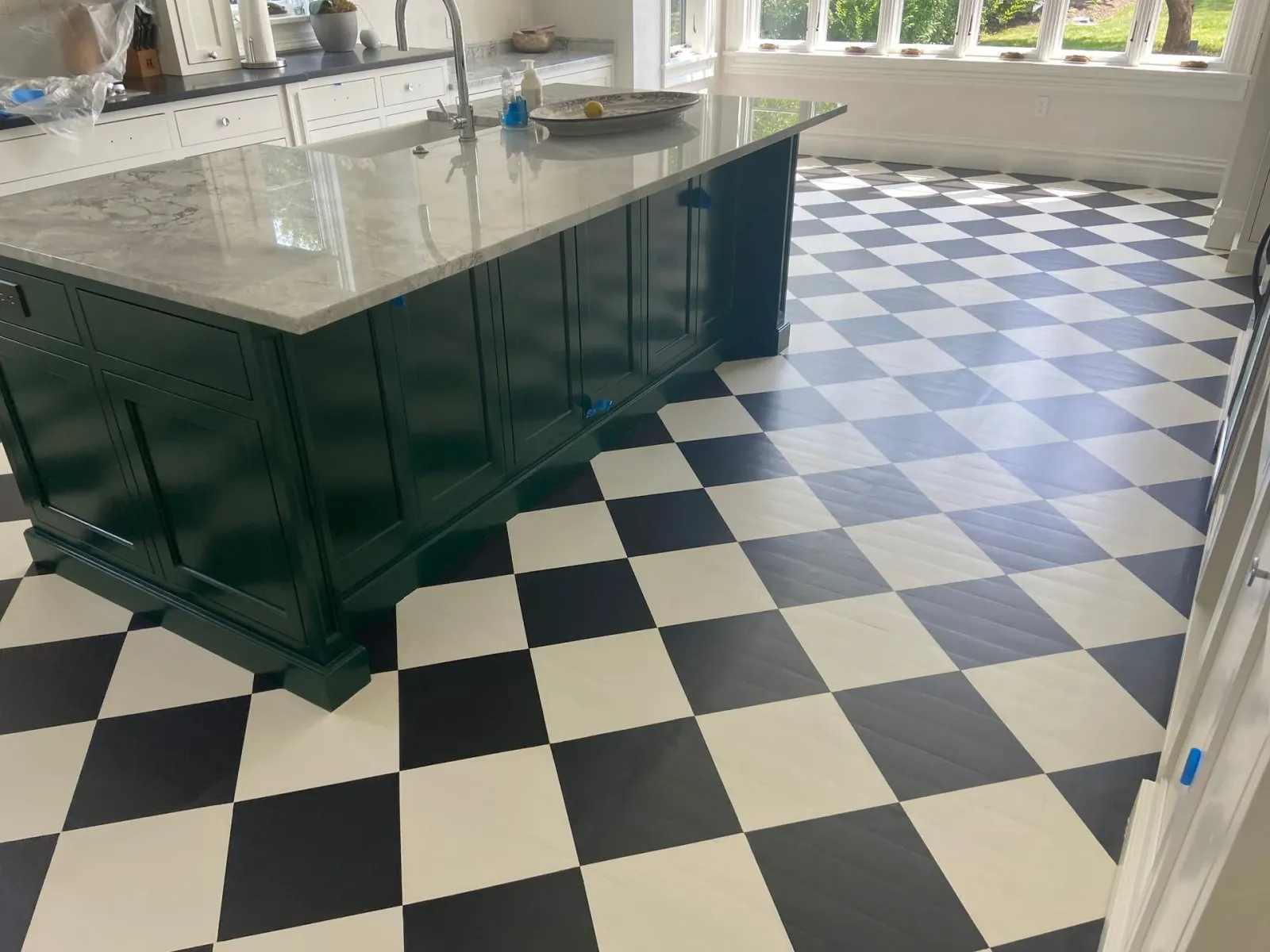 A kitchen with a black and white checkered floor