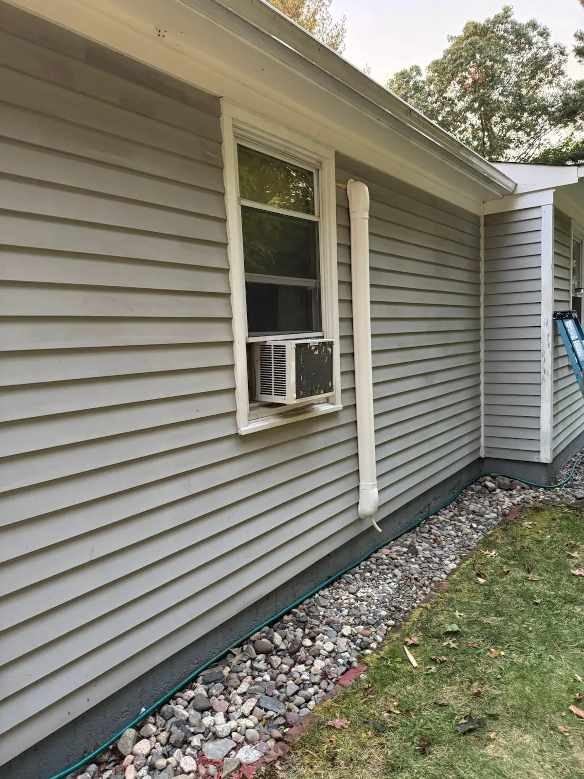 Precision installation of an exterior HVAC condenser unit on a residential property