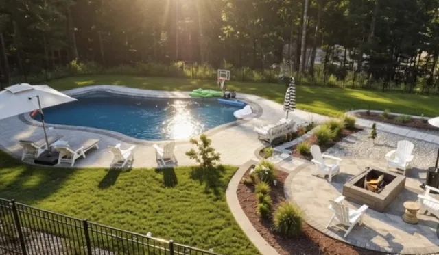Aerial view of a pool, paver patio, fire pit and landscaping near Concord, NH