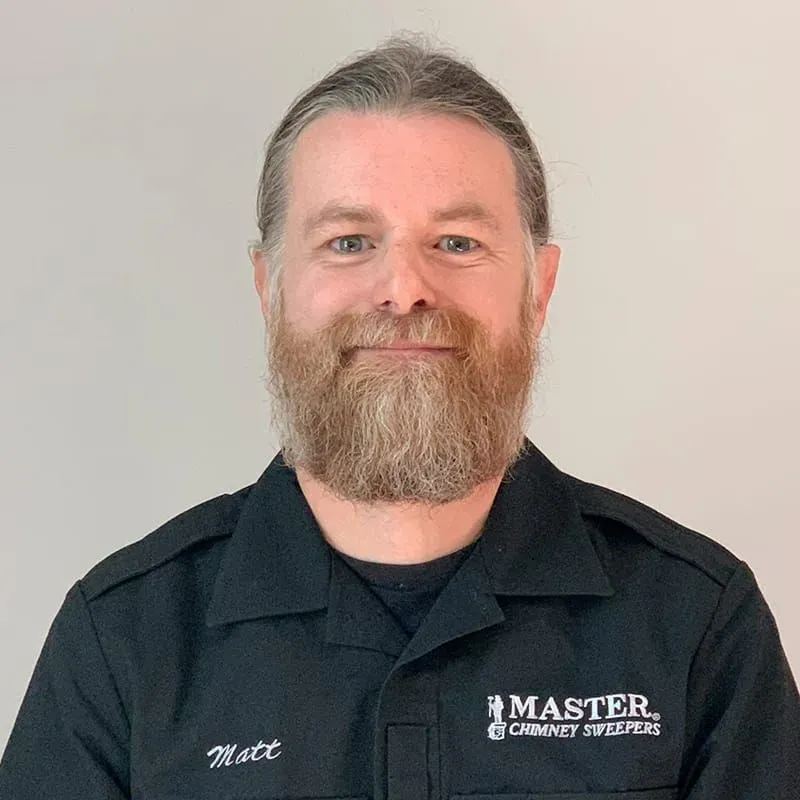 A man with a beard is wearing a black shirt.