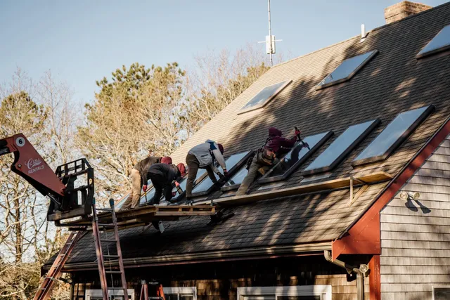 Crew installing a bank of skylights on a Cape roof