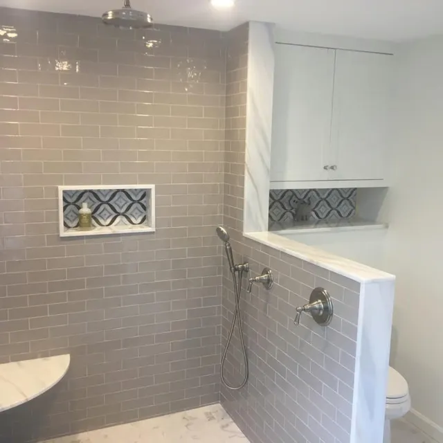Completed bathroom remodel with tiled walk-in shower