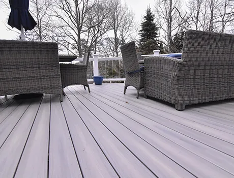 new deck with wicker furniture and glass railings