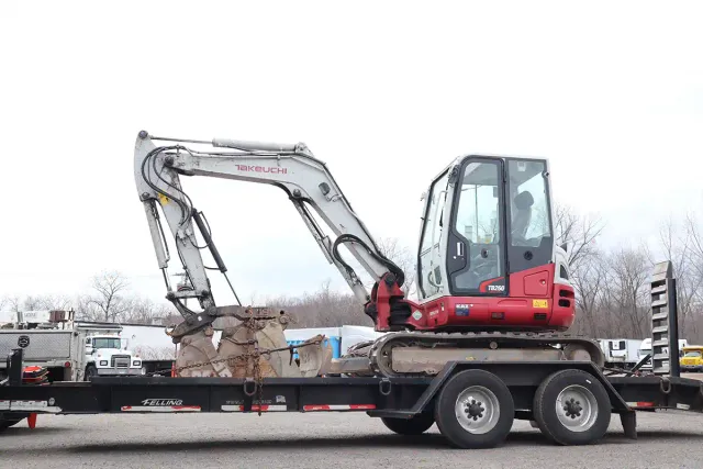 Takeuchi TB260 compact excavator loaded on a flatbed Felling trailer, wide angle view