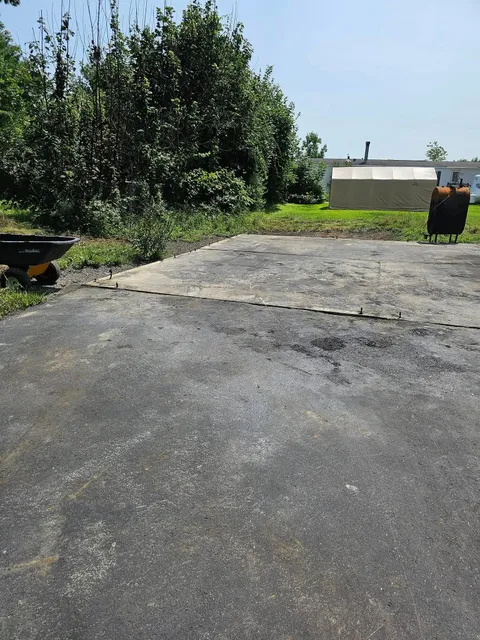 An empty parking lot with a wheelbarrow in the foreground
