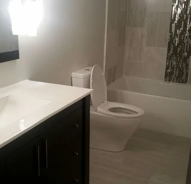 Remodeled bathroom with vanity and tile accent