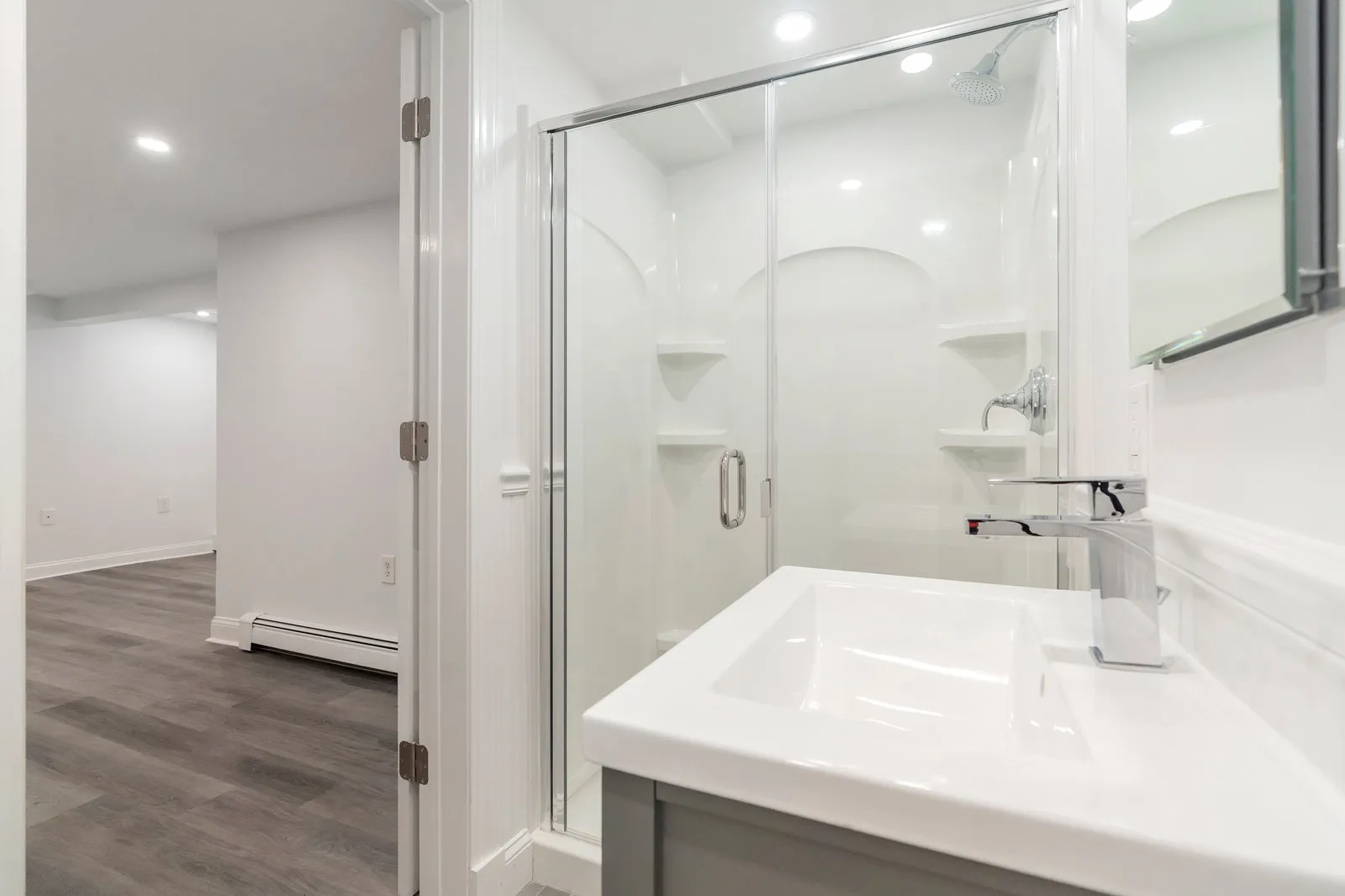 Finished lower-level bath with glass shower enclosure