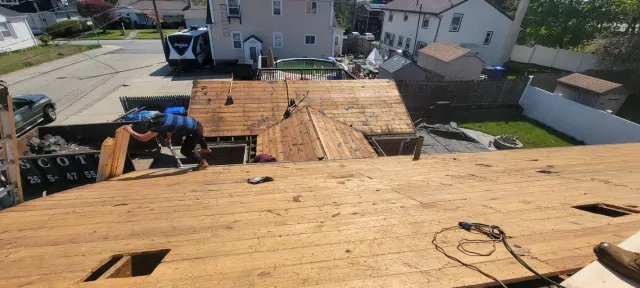 A roof is being repaired in a residential neighborhood.