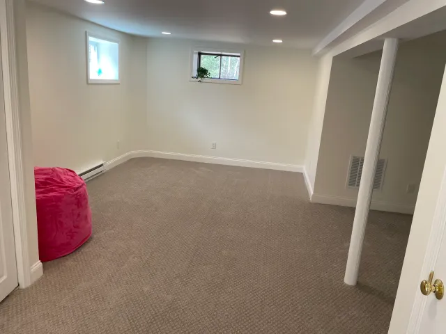 There is a pink bean bag chair in the middle of the room.