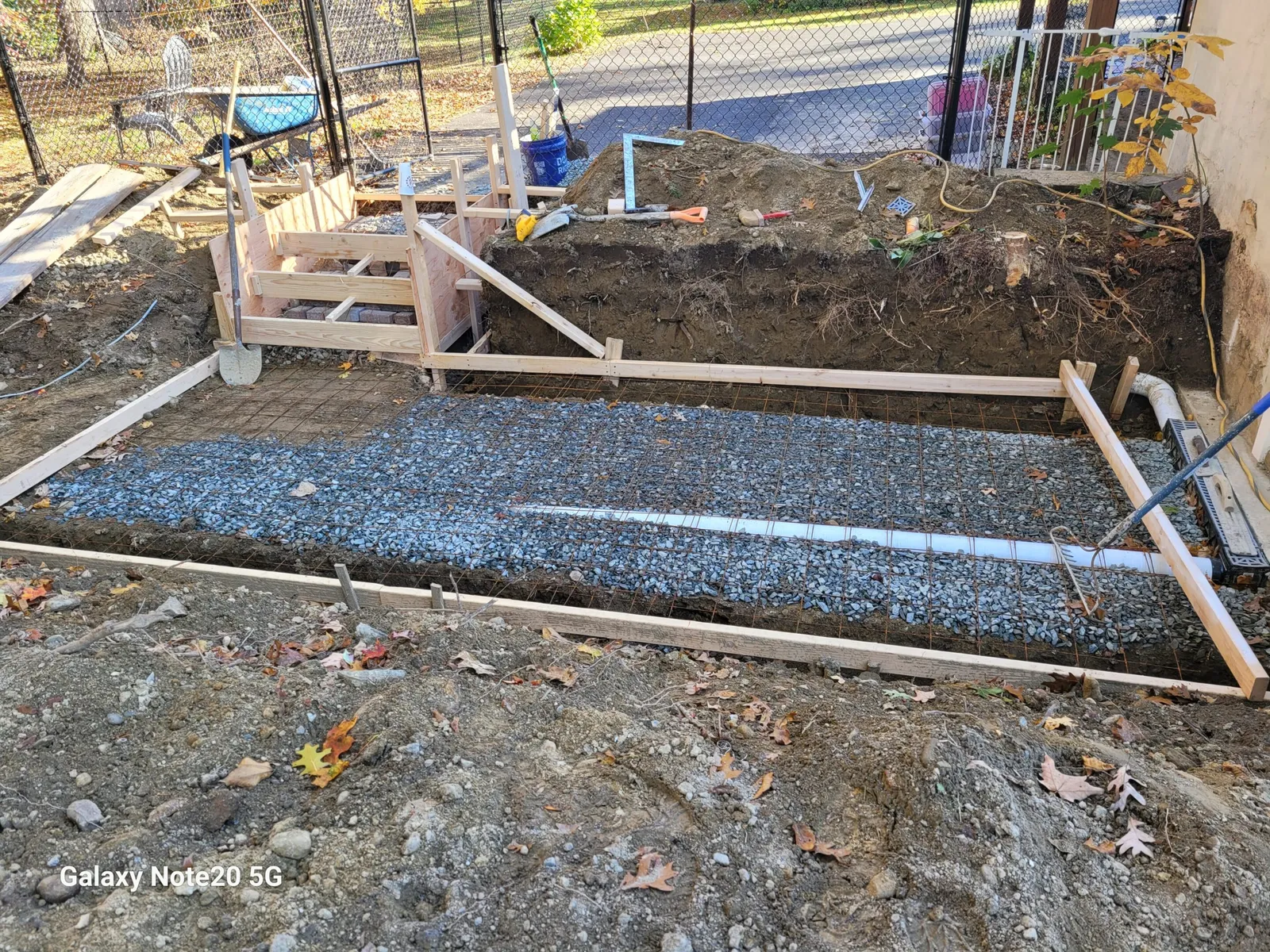 A construction site with gravel and wood.