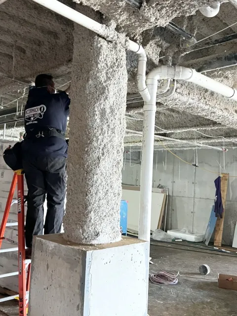 One of our crew members hanging wire in an unfinished store