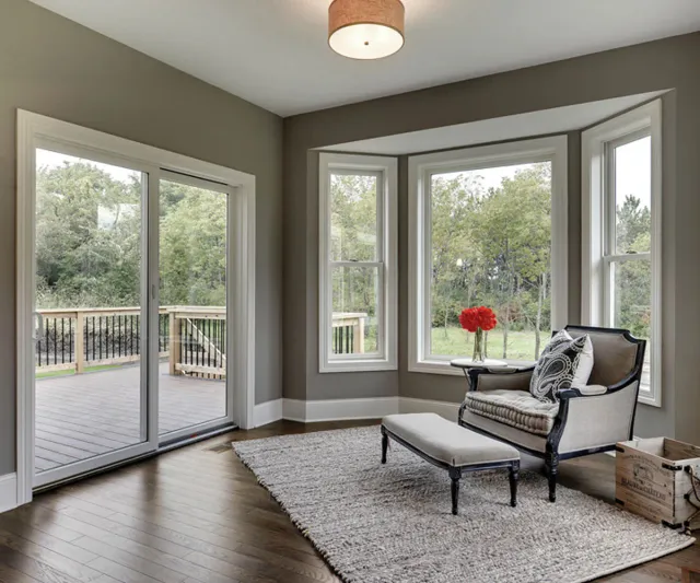 Interior sitting area with sliding patio doors, large windows, and natural light