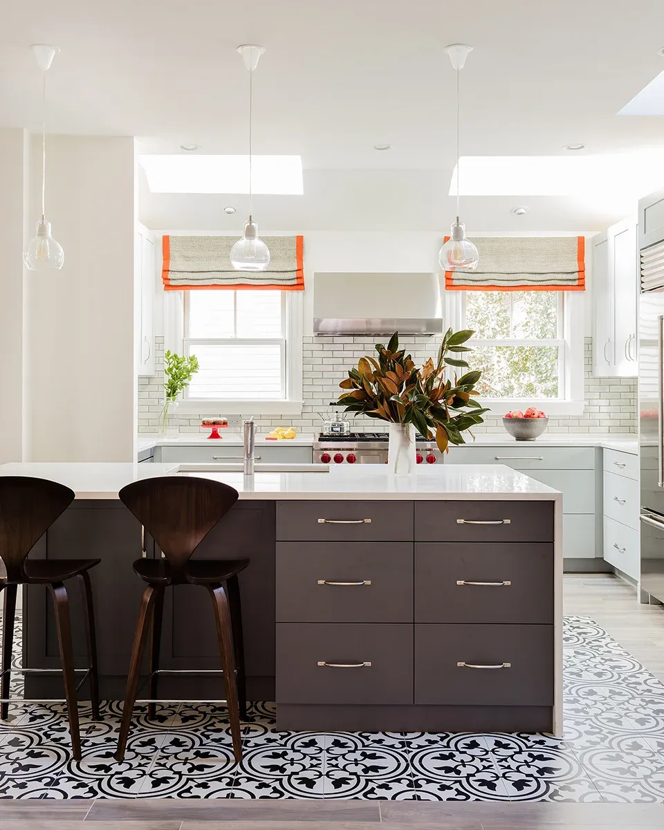 Kitchen with dark island, patterned tile floor and skylights