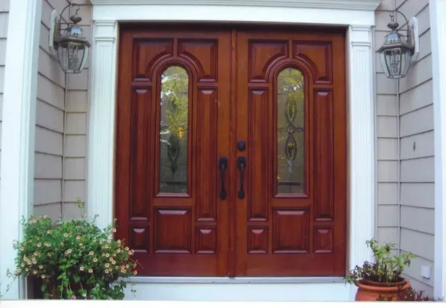 The front door of a house has a stained glass window