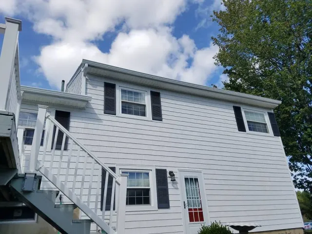 White seamless gutters on split-level home