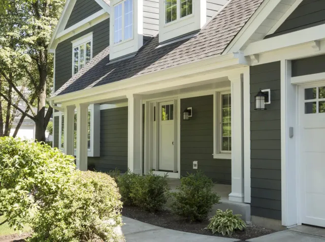 Dark gray home exterior with white trim, new windows, and updated siding