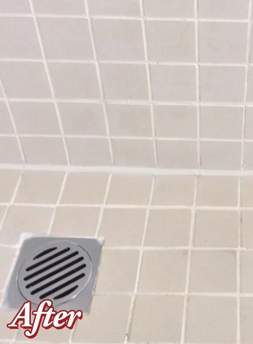 Accessible beige tiled shower with bench, grab bar, multiple shower heads and fixtures.