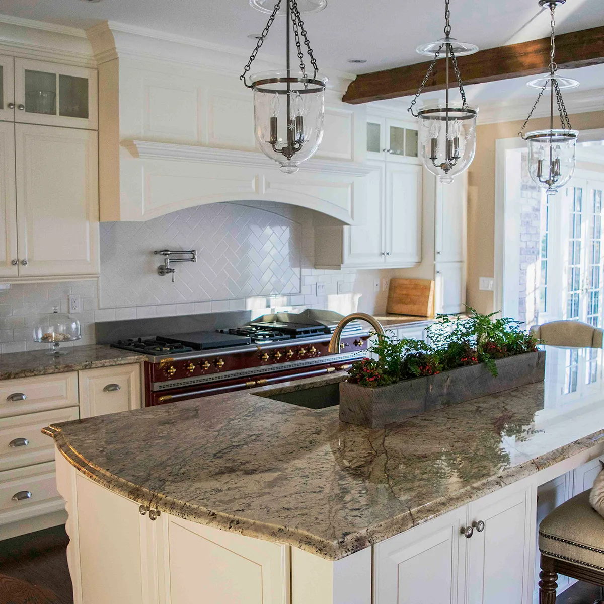 Kitchen with white cabinets, granite countertops, and a large island.